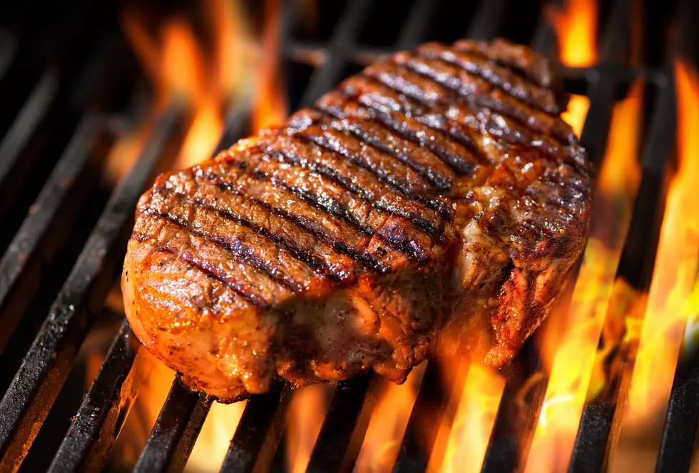 Beef steak on the grill with flames