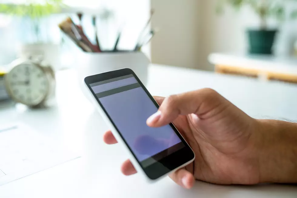 Man Typing on Smart phone